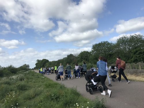 Parents walking with pushchairs